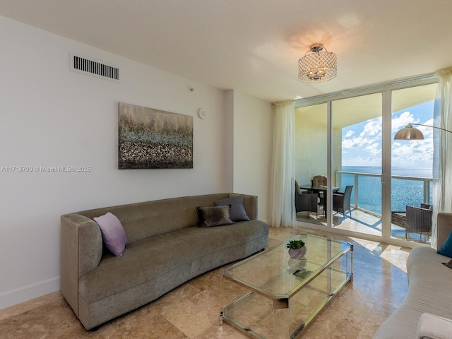 living room featuring expansive windows and a water view