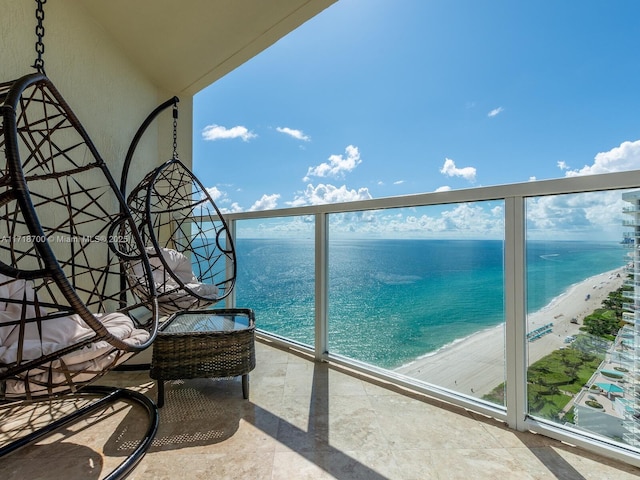 balcony with a water view and a beach view