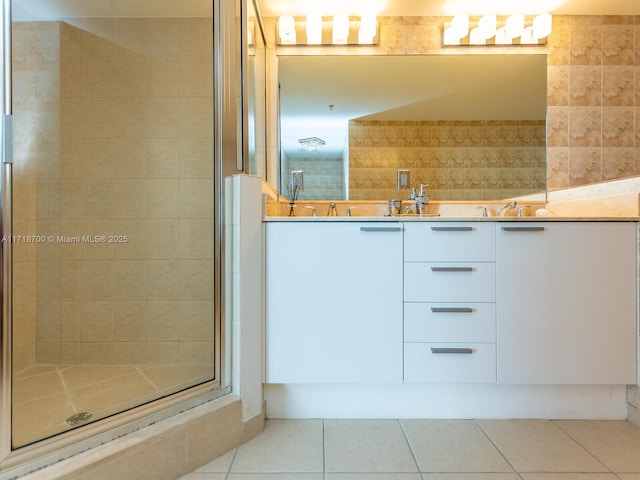 bathroom featuring tile patterned floors, vanity, and an enclosed shower