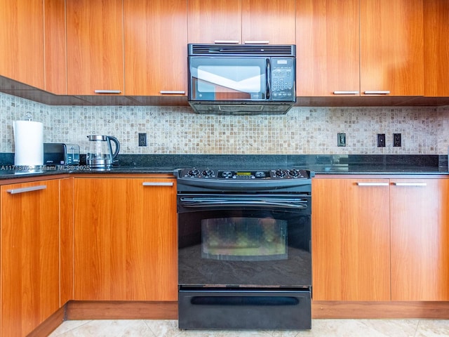 kitchen featuring black appliances, light tile patterned flooring, dark stone counters, and tasteful backsplash