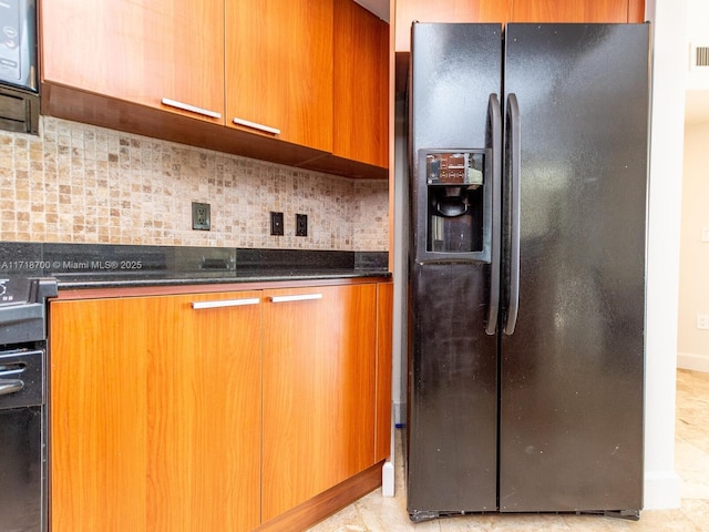 kitchen featuring black fridge with ice dispenser, range, backsplash, and dark stone counters