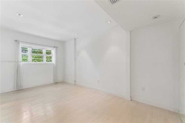 spare room with light wood-type flooring