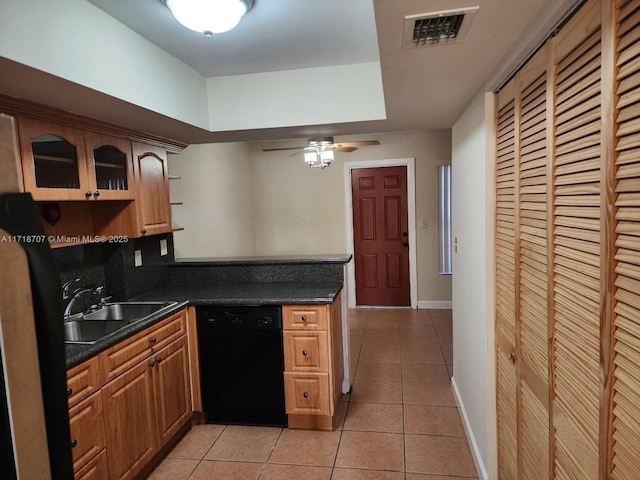 kitchen with ceiling fan, light tile patterned flooring, sink, and black dishwasher