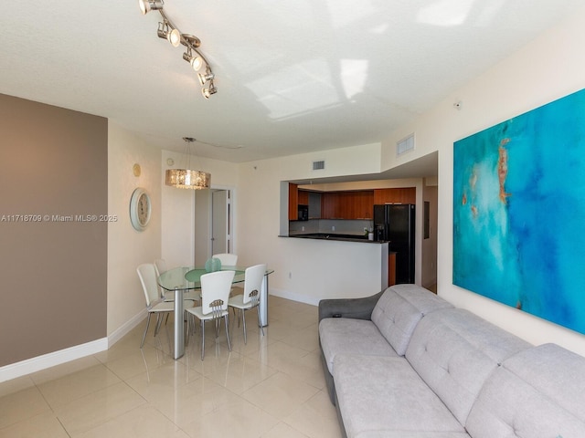 living room featuring light tile patterned floors and a textured ceiling