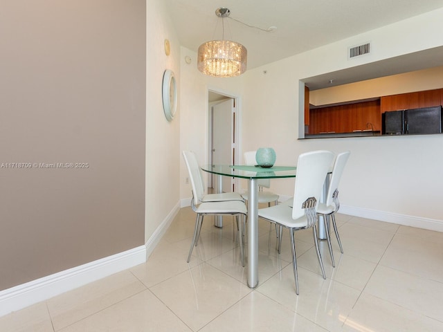 dining room featuring light tile patterned floors and a chandelier