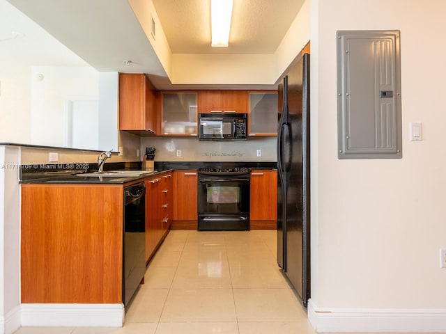 kitchen featuring black appliances, light tile patterned flooring, sink, and electric panel