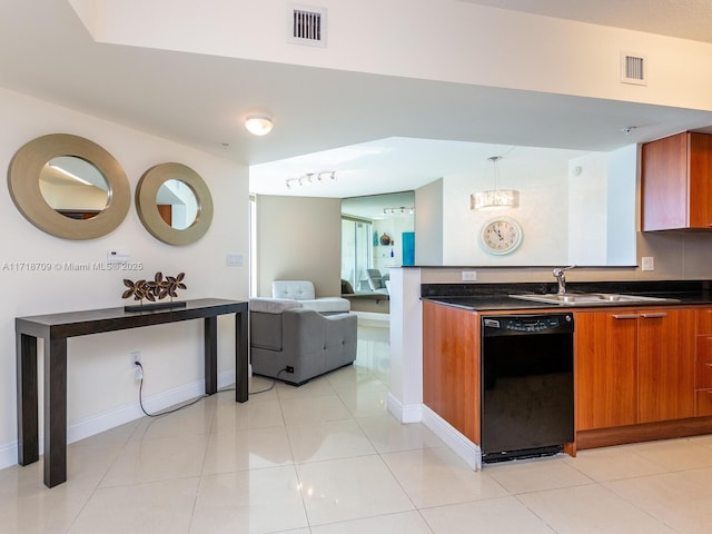 kitchen featuring sink, light tile patterned floors, pendant lighting, and black dishwasher