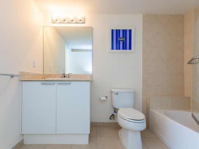 bathroom with tile patterned flooring, vanity, a tub to relax in, and toilet