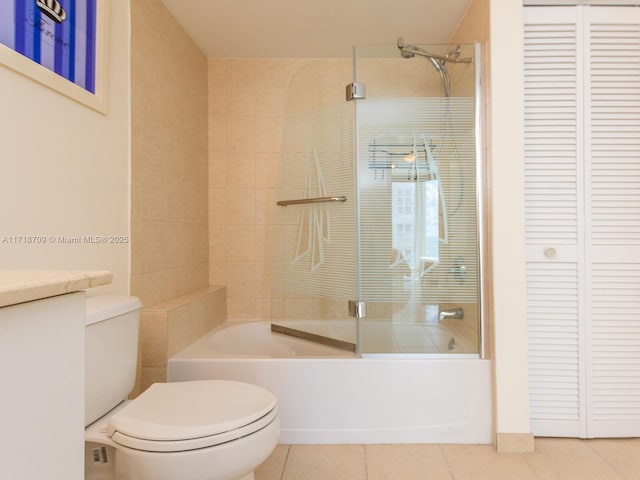 full bathroom featuring shower / bath combination with glass door, tile patterned floors, vanity, and toilet