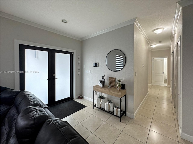 tiled foyer entrance featuring french doors, a textured ceiling, and ornamental molding