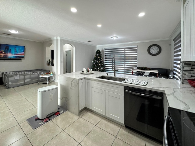 kitchen featuring kitchen peninsula, light stone countertops, white cabinets, dishwasher, and range