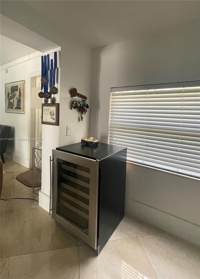 bar with wine cooler and tile patterned floors