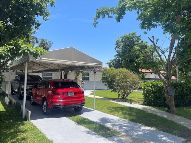 view of vehicle parking featuring a carport and a yard