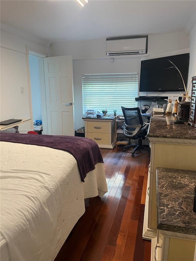 bedroom featuring dark hardwood / wood-style flooring and a wall mounted air conditioner