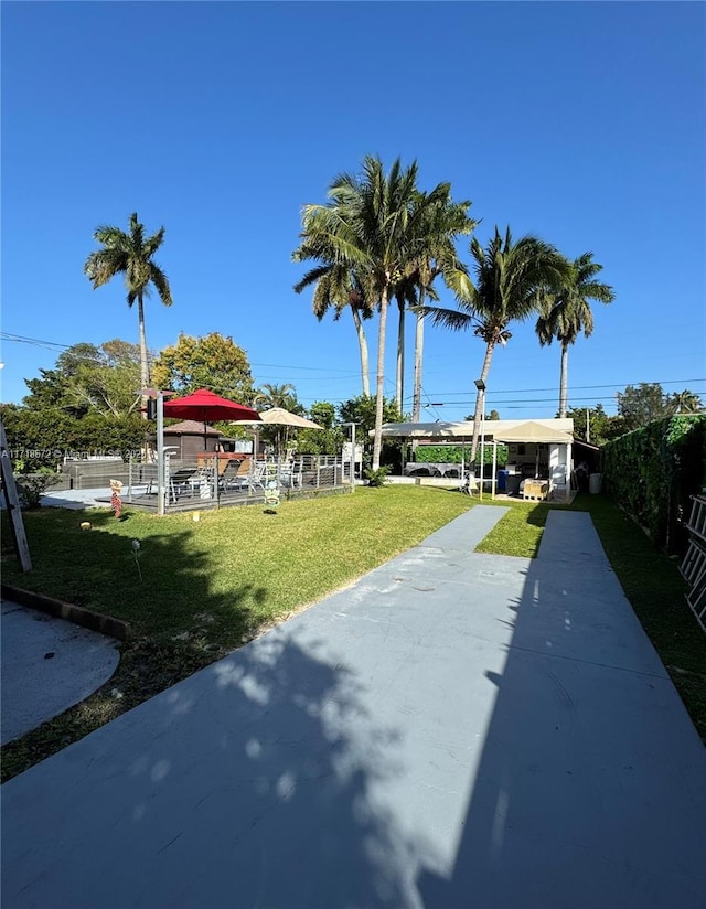 view of community featuring a patio and a lawn