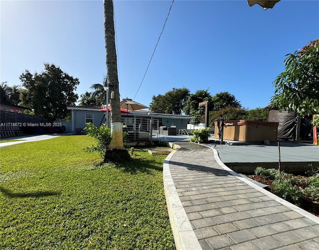 view of front facade with a hot tub and a front lawn