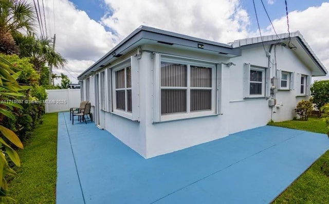 view of home's exterior featuring a yard and a patio