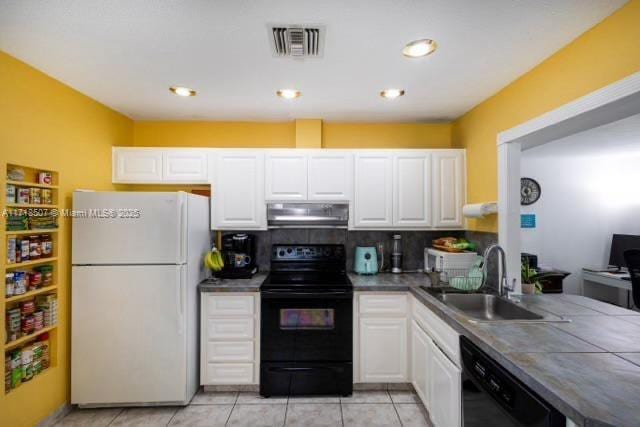 kitchen with white cabinetry, sink, tasteful backsplash, light tile patterned flooring, and black appliances