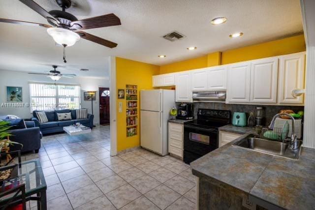 kitchen with exhaust hood, white cabinets, sink, electric range, and white fridge