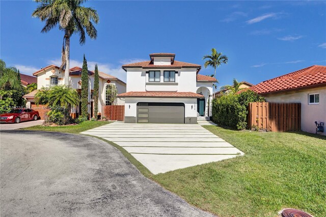 mediterranean / spanish-style home with a garage and a front yard