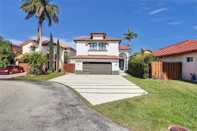 mediterranean / spanish-style home with a garage and a front yard