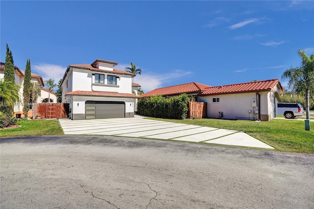 mediterranean / spanish home featuring a garage and a front lawn