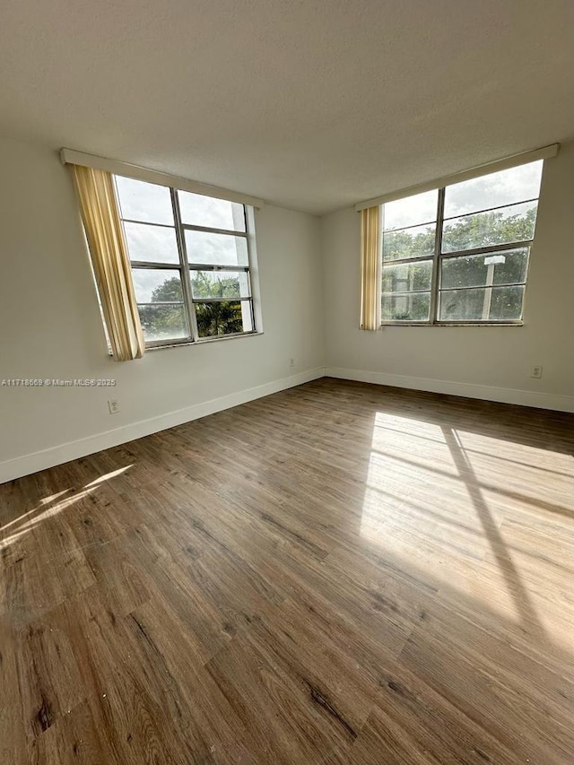 spare room with hardwood / wood-style flooring