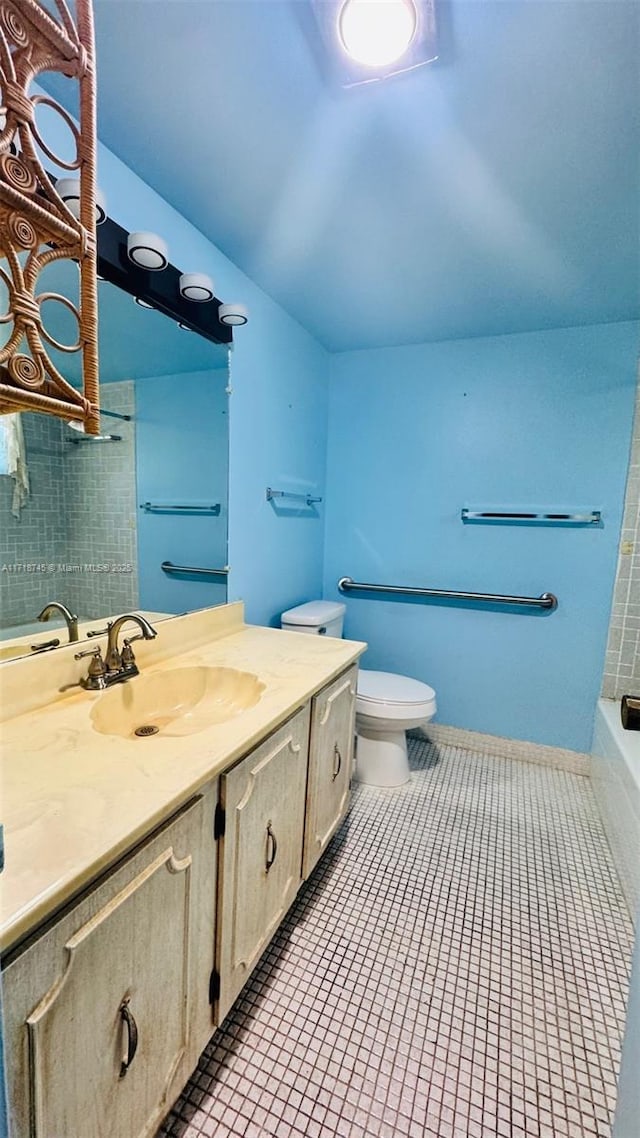 bathroom with tile patterned flooring, vanity, and toilet