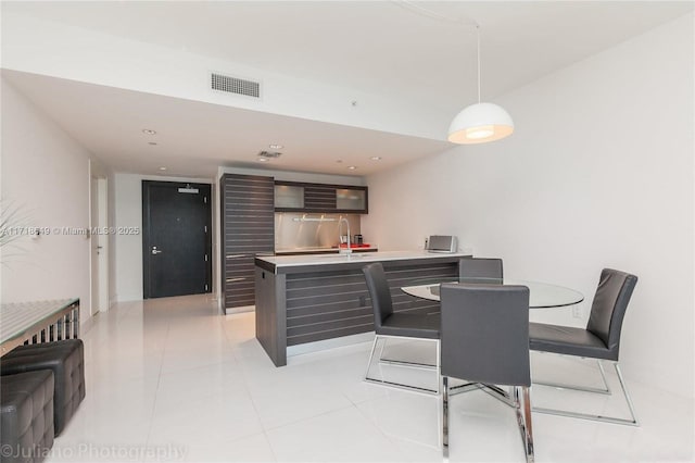 tiled dining room with sink