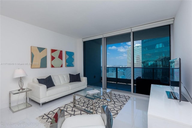 living room with tile patterned floors and a wall of windows