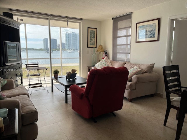 living room with light tile patterned flooring, floor to ceiling windows, and a textured ceiling