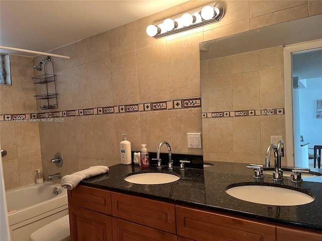 full bathroom with vanity, toilet, tile walls, and tiled shower / bath