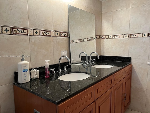 bathroom featuring vanity and tile walls