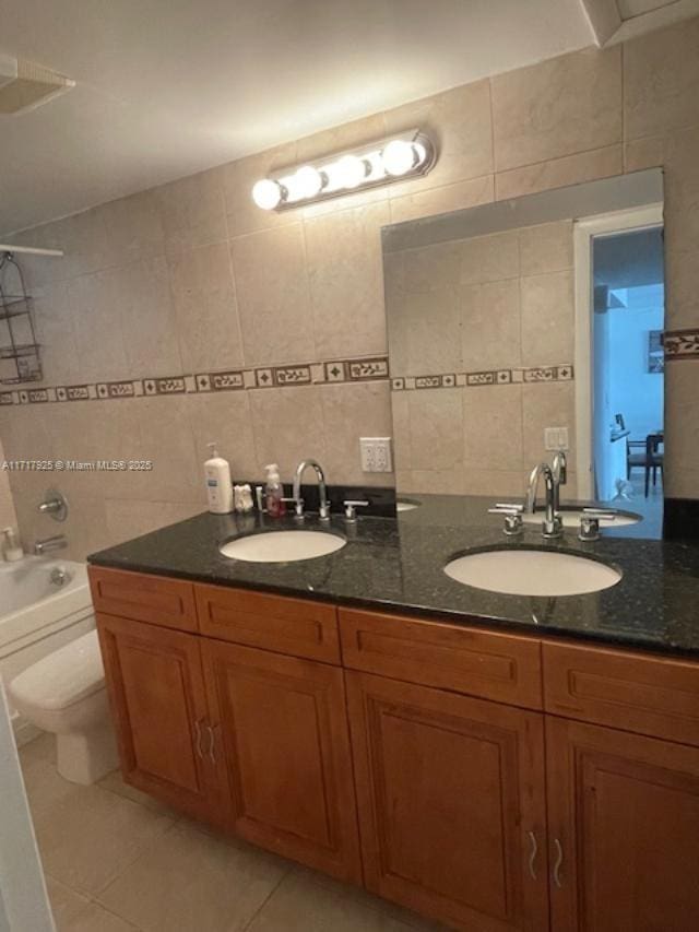 full bathroom featuring vanity,  shower combination, tile patterned flooring, and tile walls