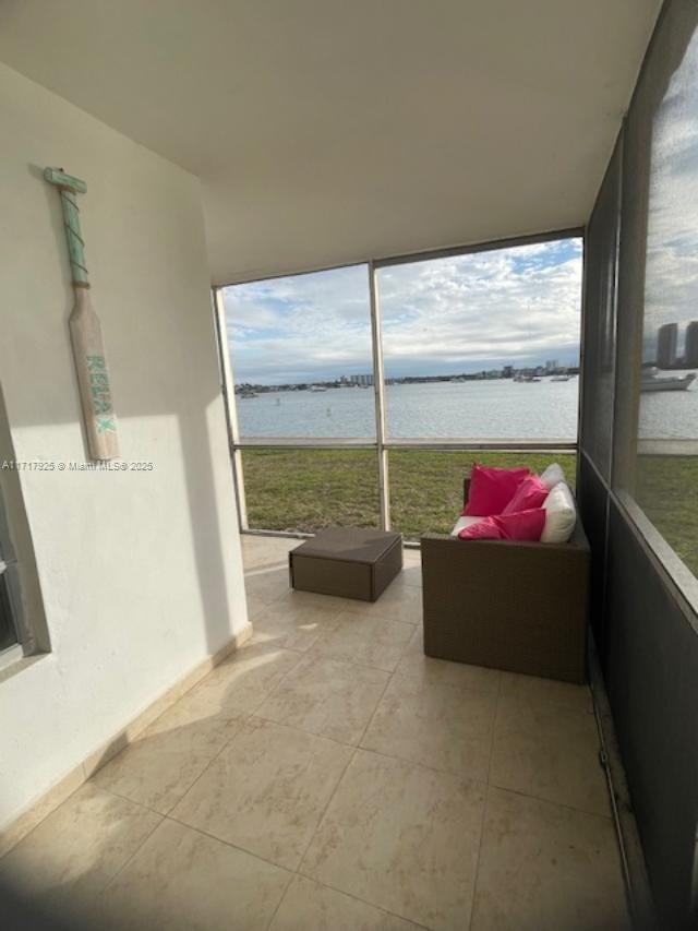 sunroom / solarium with a water view