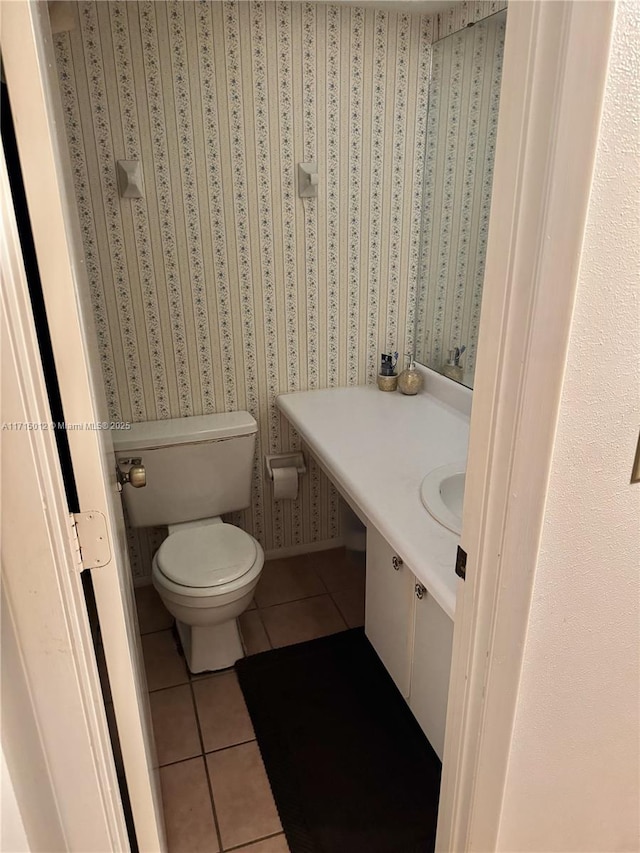 bathroom with tile patterned flooring, vanity, and toilet