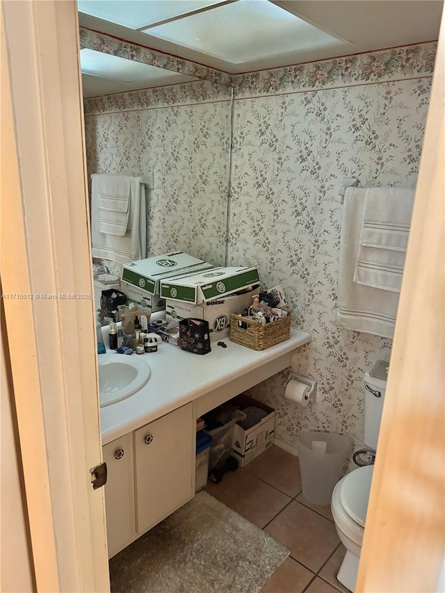 bathroom featuring toilet, vanity, and tile patterned floors