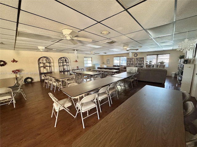 dining area featuring a paneled ceiling, ceiling fan, and hardwood / wood-style flooring