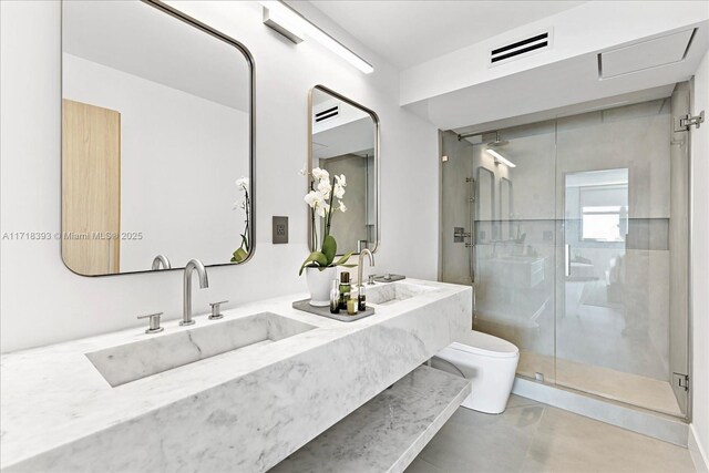 bathroom featuring vanity, an enclosed shower, and toilet