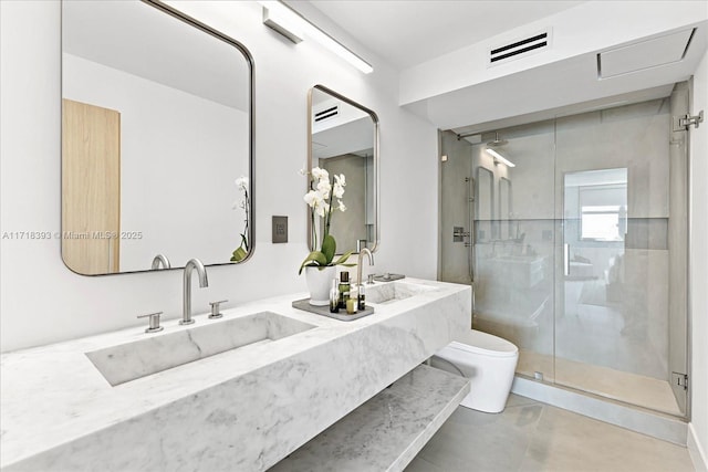 bathroom with vanity, tile patterned floors, a shower with door, and toilet