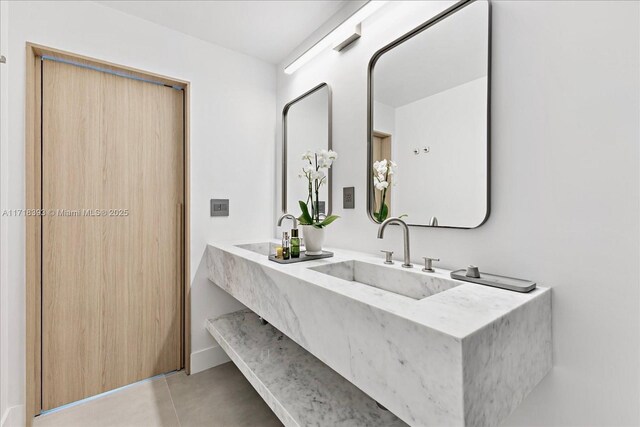 bathroom featuring tile patterned flooring and vanity