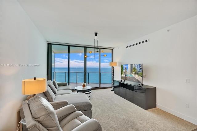 carpeted living room featuring a wall of windows