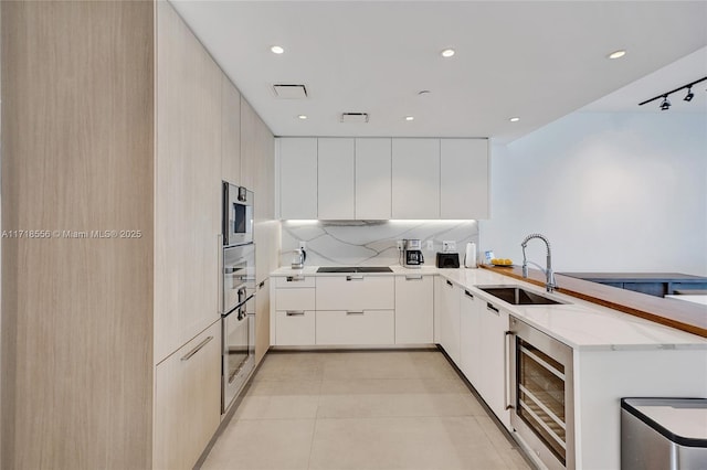 kitchen featuring sink, wine cooler, black electric cooktop, light tile patterned flooring, and kitchen peninsula