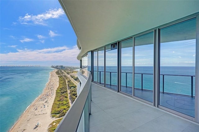 balcony with a beach view and a water view