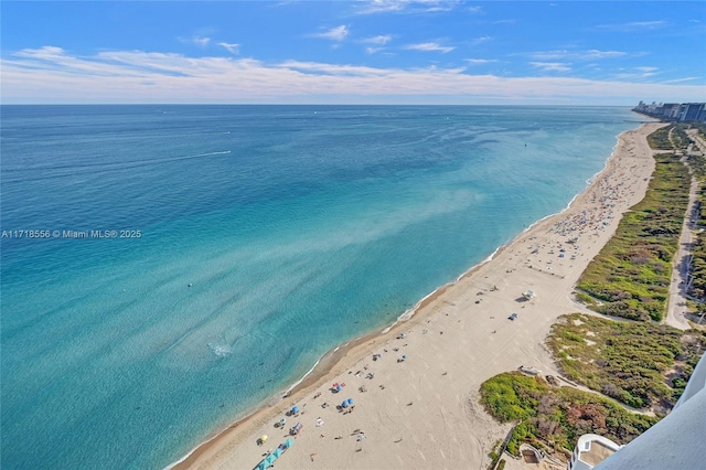 bird's eye view featuring a view of the beach and a water view