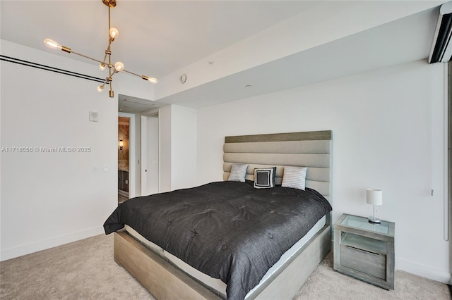 carpeted bedroom with an inviting chandelier