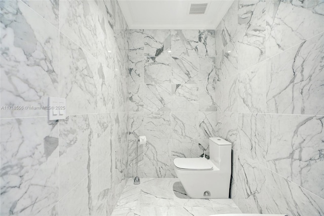 bathroom featuring toilet and crown molding