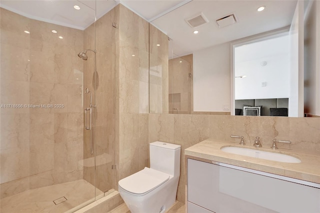 bathroom with walk in shower, vanity, tile walls, and toilet