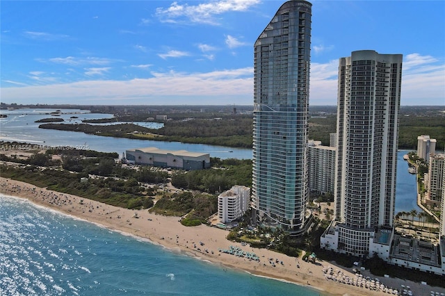 birds eye view of property with a water view and a view of the beach