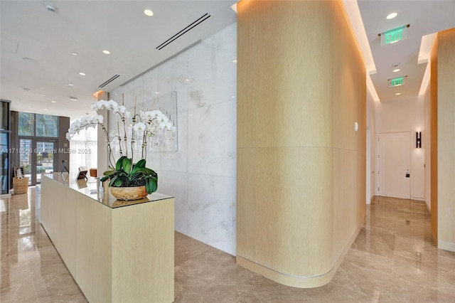 hallway with expansive windows and tile walls